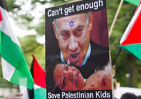 A poster depicting PM Netanyahu and Palestinian flags in front of the Israeli embassy in Berlin. (Photo: Anti Defamation League)