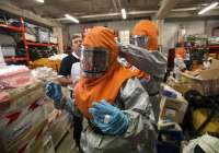 A team suits up before treating Ebola patients. (Photo: REUTERS/Philippe Wojazer)