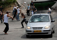 An Israeli family attacked by Arab rioters. (Photo:  Yonatan Sindel / Flash90)