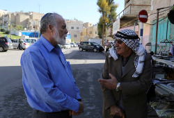 A Palestinian and an Israeli seen talking  in Hebron, on December 10, 2014. (Photo: Gershon Elinson/Flash90)