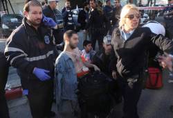 A medic and policewoman treat one of the victims. (Photo: Flash90)