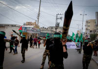 Masked terrorists march in a rally