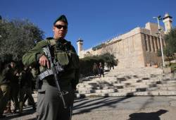 An Israeli soldier stands guard outside the Cave of the Patriarchs in Hebron. (Nati Shohat/ Flash90)