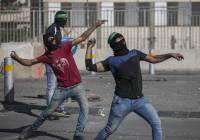 Palestinians throw rocks at Israeli border police.