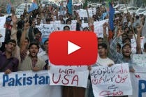 Pakistani protesters hold placard as they shout anti-U.S. slogans