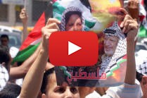 Palestinians hold posters showing Dalal Mughrab