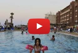 In this Thursday, July 30, 2015 photo, Palestinian family members enjoy themselves at a swimming pool of the Blue Beach Resort in Gaza City. (AP Photo/Adel Hana)