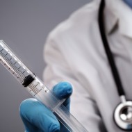 doctor holding syringe