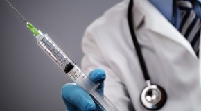 doctor holding syringe