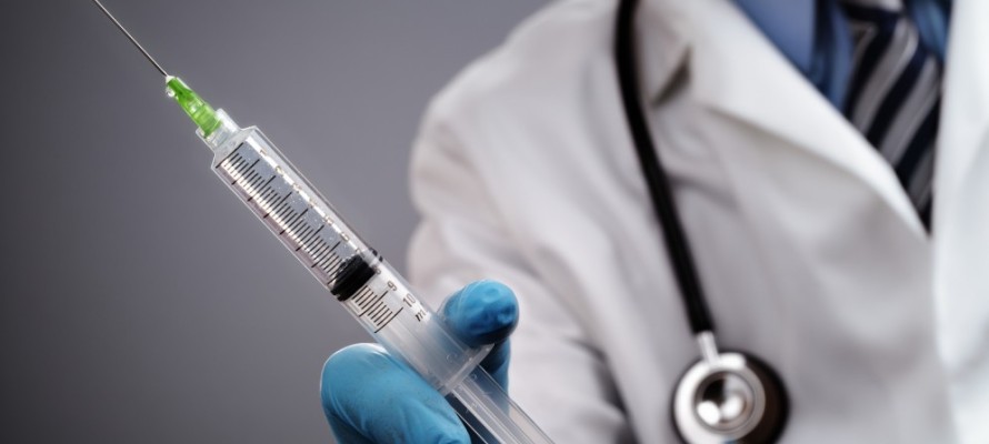 doctor holding syringe