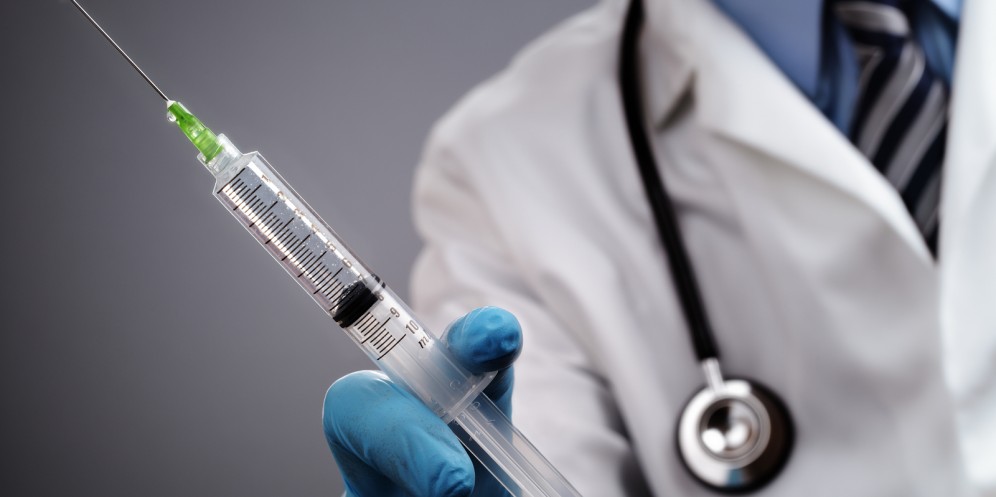 doctor holding syringe