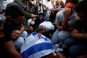 Friends and family grieve at the funeral for three murdered teens on Tuesday. (Photo: Yonatan Sindel/Flash90)