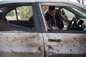 This man's car was hit by a rocket near Sderot.  (Photo: Hadas Parush/ Flash90) 
