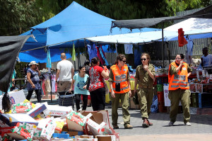 Home Front Command personnel walking through the market area of the southern city of Sderot on Sunday. (Photo: Yossi Zamir/Flash90)