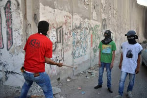 Palestinians seen breaking a piece of the separation wall in the  city of Abu Dis, near Ramallah. (Photo: Sliman Khader/Flash90)