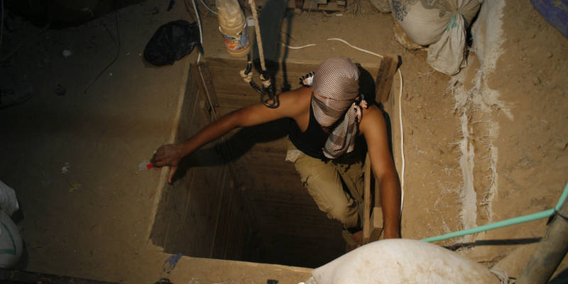 A terrorist emerges from a tunnel. (Khaled Omar/propaimages)