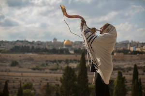 A man blows a shofar on the Mount of Olives. (Photo: Yonatan Sindel/Flash90 )
