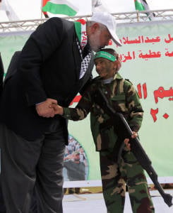 Hamas leader Ismail Haniyah with a "graduate" of a Hamas terror camp for children. (Photo: paldf.net)
