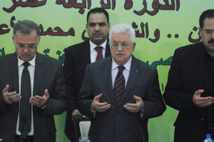 Palestinian President Mahmoud Abbas (C) prays before delivering a statement in Ramallah last year, calling for "all means" to keep Jews away from the Temple Mount. (FLASH90)