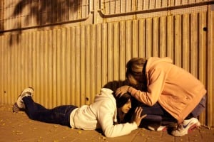 Ashkelon women take cover from Hamas rocket fire. ( Edi Israel/Flash90)