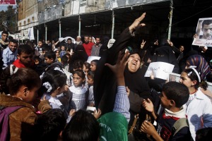 Palestinians scatter sweets in celebration of the attack on a Jerusalem synagogue.