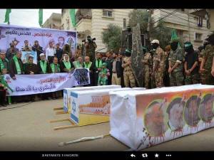 Hamas proudly display a coffin with the photos of the four rabbis they slaughtered. (Photo: IDF)