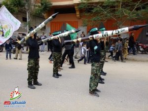 Hamas terrorists march with models of rockets they fire at Israeli civilians. (Photo: IDF) 