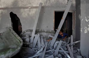 A boy plays inside a destroyed building in Gaza. (Photo: Emad Nassar/Flash90)