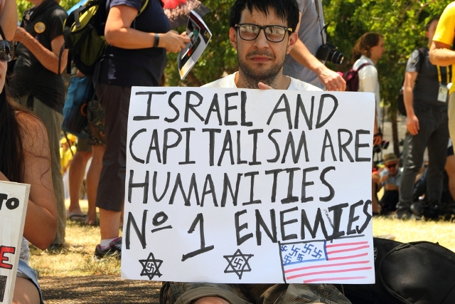 A demonstrator invokes Nazi imagery in his anti-Israel "protest." (Shutterstock)