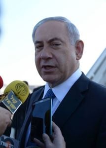 PM Netanyahu speaks with the media before boarding a plane to Rome. (Photo: Amos Ben Gershom/GPO) 