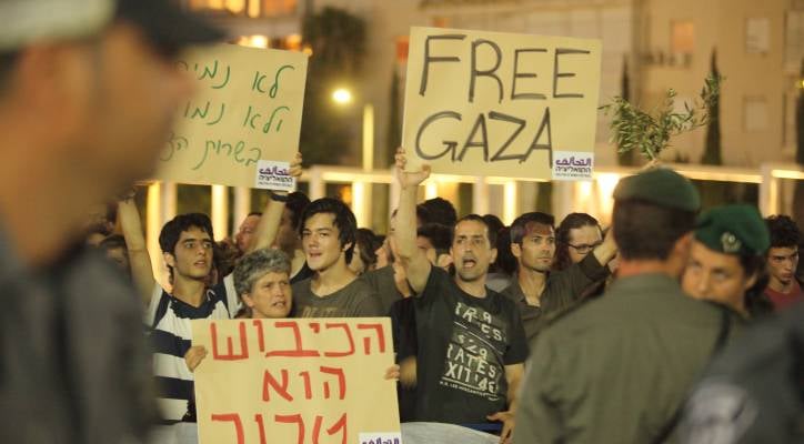 Israeli left wing activists holding placards during a demonstration. (Photo by Yossi Aloni/Flash90)