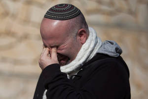 A mourner at the funeral on Tuesday for four French-Jewish victims of Islamic terror. (Photo: Yonatan Sindel/Flash90)
