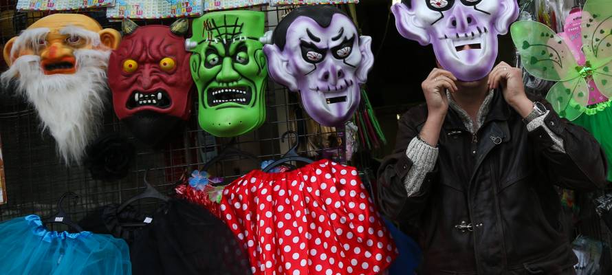 An Israeli man offers costumes before the upcoming Jewish holiday of Purim. (Nati Shohat/Flash 90)