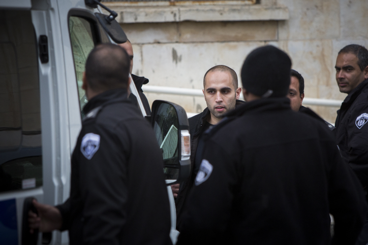 Rami Alami (2L) An Arab attorney from east Jerusalem seen surrounded by guards after a court hearing in the Magistrate's Court in Jerusalem on March 12, 2015. (Yonatan Sindel/Flash90)