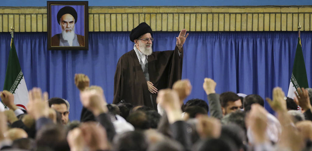 Supreme Leader Ayatollah Ali Khamenei waves while attending a meeting with a group of environmental officials and activists at his residence in Tehran, Iran, Sunday, March, 2015. (AP/Office of the Iranian Supreme Leader)