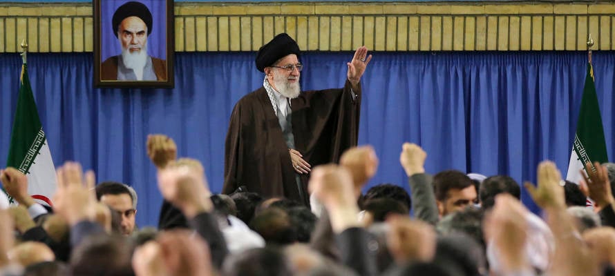 Supreme Leader Ayatollah Ali Khamenei waves while attending a meeting with a group of environmental officials and activists at his residence in Tehran, Iran, Sunday, March, 2015. (AP/Office of the Iranian Supreme Leader)