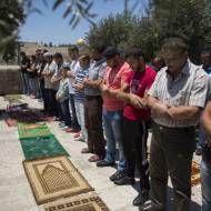 Palestinian men pray.