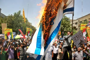 Iranians burn an Israeli flag at Quds Day rally. (AP/Ebrahim Noroozi)