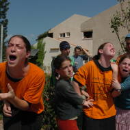 Jewish settlers cry as a soldier forces them to evacuate their home in the Jewish settlement of Neve Dekalim. Photo by Flash90