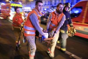 A woman is evacuated from the Bataclan theater after an Islamic terror attack in Paris. (AP/Jerome Delay)