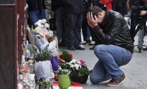 Man grieves in Paris on Saturday following Islamic terror attacks the previous night. (AP)