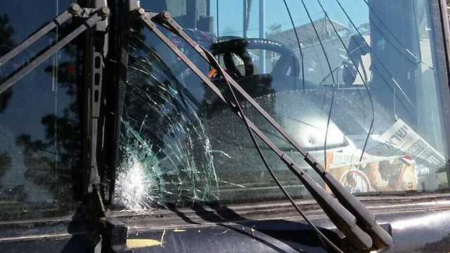 Shattered window of Breaking the Silence tour bus