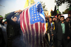 Iranian protesters burn an American flag during an anti-American rally in Tehran. (AP)