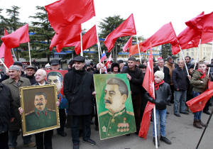 Georgians carry portraits of former Soviet dictator Joseph Stalin and red flags to mark the 136th anniversary of his birth in his home town of Gori, some 80 km (50 miles) west of the Georgian capital Tbilisi, Georgia. (AP Photo/ Shakh Aivazov)