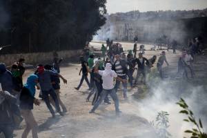 Palestinian students hurl stones at Israeli troops during clashes following a protest near Al-Quds University in the village of Abu Dis, near Jerusalem, on Oct. 28, 2015. (AP/Majdi Mohammed)