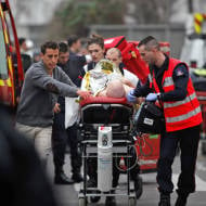 An injured person is rushed to hospital in Paris following Islamic terror attack at Charlie Hebdo headquarters in Jan 2015. (AP/Thibault Camus)