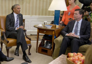 FBI Director James Comey, right, listens to President Barack Obama, left, speak to members of the media in the Oval Office of the White House in Washington, Monday, June 13, 2016, after receiving an update on the massacre at an Orlando nightclub. Comey says the gunman in the Orlando nightclub attack that killed 49 people had "strong indications of radicalization" and was likely inspired by foreign terrorist organizations. (AP Photo/Pablo Martinez Monsivais)