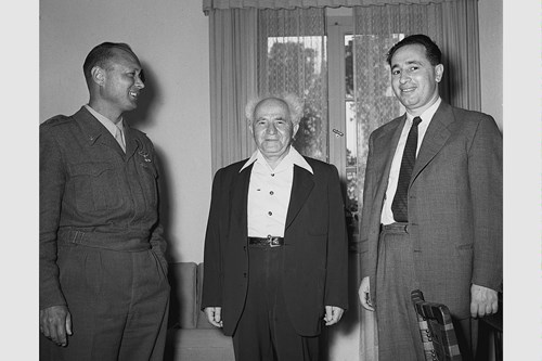 1955 - MIN. OF DEFENCE DAVID BEN GURION CHIEF OF STAFF MOSHE DAYAN (L) AND DIRECTOR GENERAL OF DEFENCE MIN. SHIMON PERES AT HAKIRYA IN TEL AVIV. (GPO)