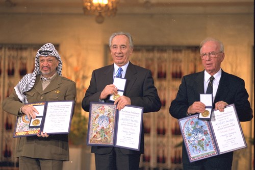 1994 - NOBEL PEACE PRIZE LAUREATES YASIR ARAFAT, SHIMON PERES AND YITZHAK RABIN DISPLAY THEIR AWARDS. (GPO)