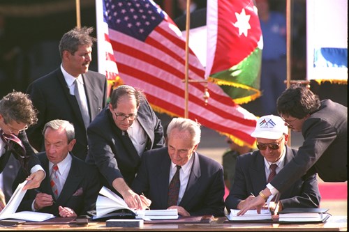 1994 - THE FOREIGN MINISTERS OF THE (L.TO R.) U.S., ISRAEL AND RUSSIA SIGNING COPIES OF THE ISRAEL-JORDAN PEACE TREATY. (GPO)